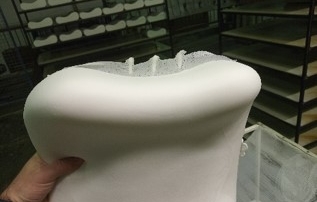 White pillow handled from a human hand