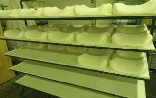 White pillows on shelves that will be used for use case 4 from the robotic manipulator